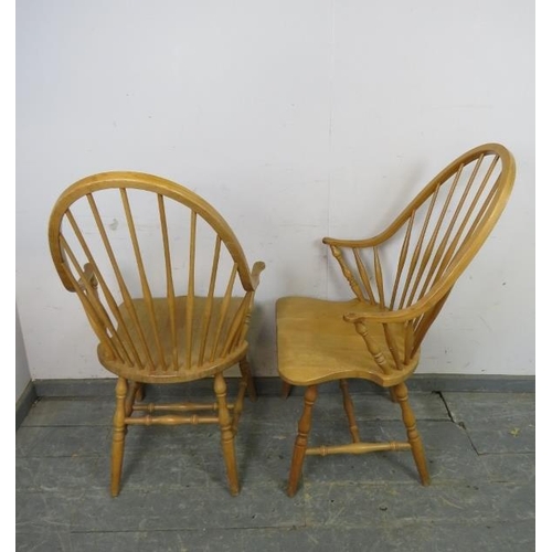 731 - A set of four beech Windsor style carver chairs, the hoop backs with turned spindles, above shaped s... 