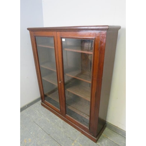 733 - A Victorian mahogany enclosed bookcase of good colour, the glazed doors opening onto four height adj... 