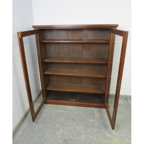 733 - A Victorian mahogany enclosed bookcase of good colour, the glazed doors opening onto four height adj... 