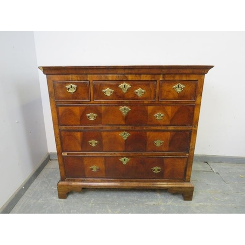 738 - An 18th century flame mahogany chest, housing three short and three long graduated drawers, cross ba... 