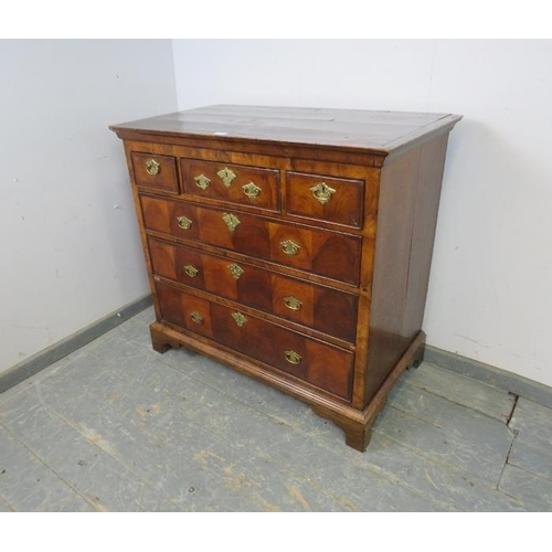 738 - An 18th century flame mahogany chest, housing three short and three long graduated drawers, cross ba... 