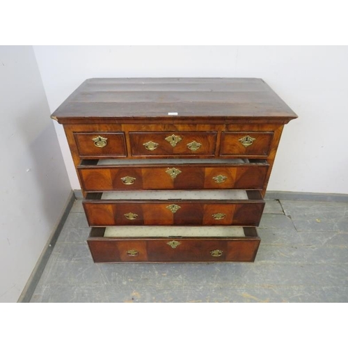 738 - An 18th century flame mahogany chest, housing three short and three long graduated drawers, cross ba... 