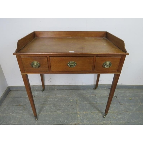 739 - An Edwardian mahogany washstand, the ¾ gallery above three short drawers with pressed brass handles,... 