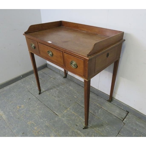 739 - An Edwardian mahogany washstand, the ¾ gallery above three short drawers with pressed brass handles,... 