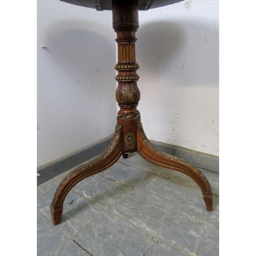 743 - A 19th century mahogany tilt-top wine table, the top with gadrooned edge, on a profusely carved trip... 