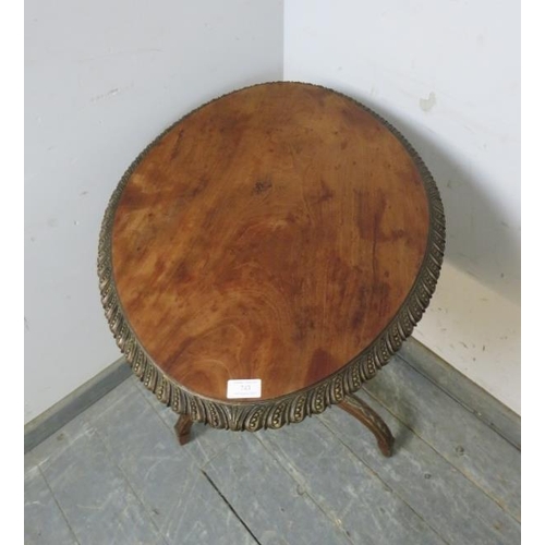 743 - A 19th century mahogany tilt-top wine table, the top with gadrooned edge, on a profusely carved trip... 