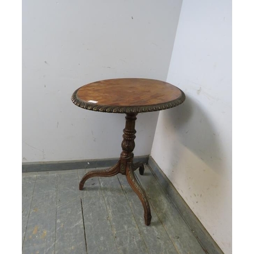 743 - A 19th century mahogany tilt-top wine table, the top with gadrooned edge, on a profusely carved trip... 