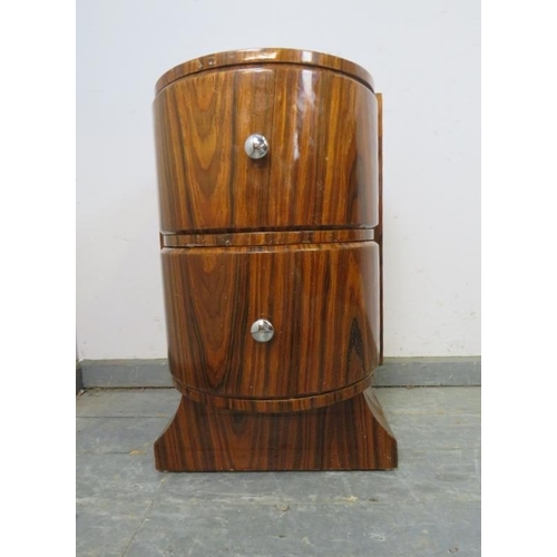 745 - An Art Deco Period lacquered rosewood bow-fronted side cabinet, housing two drawers with chromed kno... 