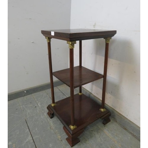 747 - A reproduction mahogany three-tier whatnot, the plain columns with gilt brass Corinthian Style capit... 