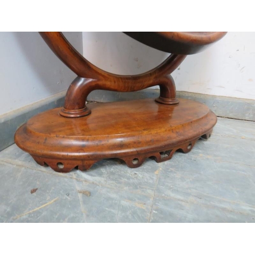 750 - A large 19th century oval mahogany swing vanity mirror, the acanthus carved uprights on a plinth bas... 