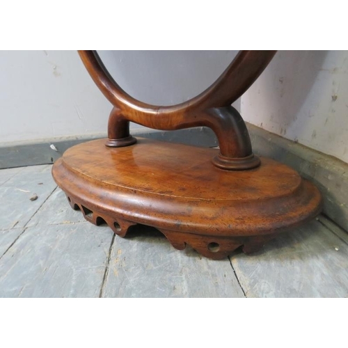 750 - A large 19th century oval mahogany swing vanity mirror, the acanthus carved uprights on a plinth bas... 