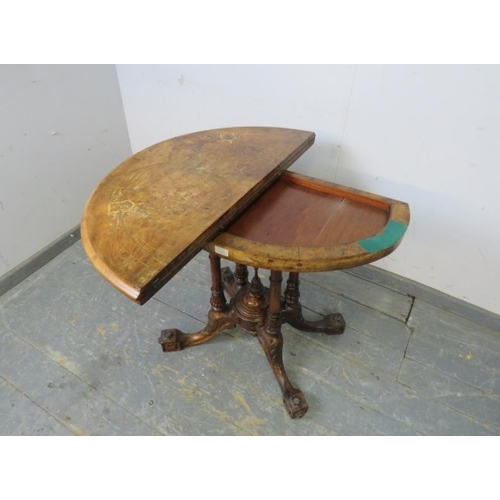 755 - A Victorian burr walnut demi-lune turnover card table, the top with marquetry inlay, on a cluster co... 