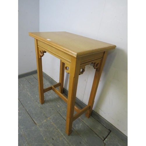 762 - A vintage light oak hall table in the ecclesiastical taste with carved and pierced fretwork decorati... 