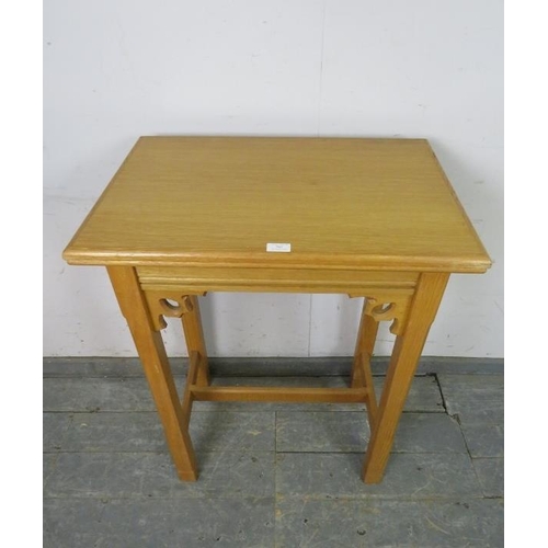 762 - A vintage light oak hall table in the ecclesiastical taste with carved and pierced fretwork decorati... 