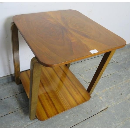 783 - An Art Deco period walnut two-tier table , the quarter veneered top with curved corners, on square s... 