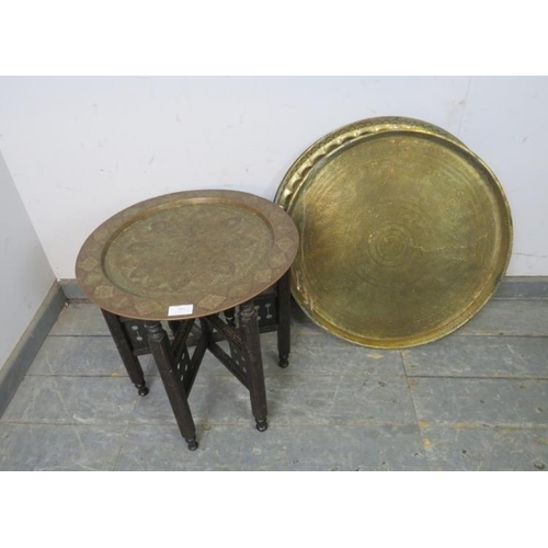 804 - An early 20th century Benares table, the hand-tooled brass tray top coloured and engraved, on a fold... 