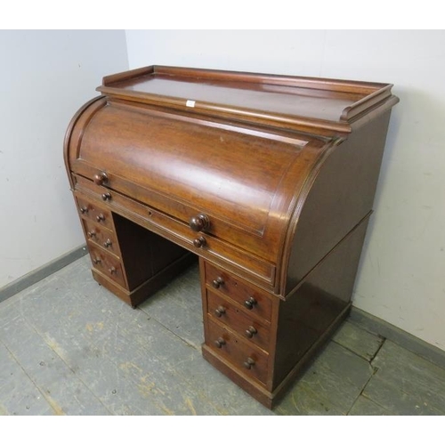 806 - A Victorian mahogany cylinder top desk, the rising lid opening onto a fitted interior with maple ven... 