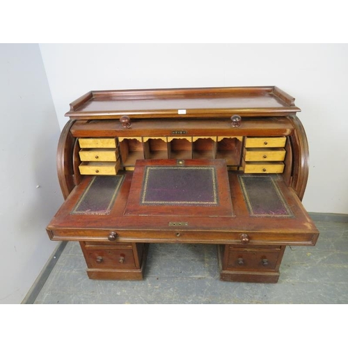 806 - A Victorian mahogany cylinder top desk, the rising lid opening onto a fitted interior with maple ven... 