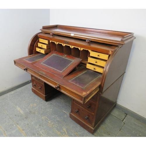 806 - A Victorian mahogany cylinder top desk, the rising lid opening onto a fitted interior with maple ven... 