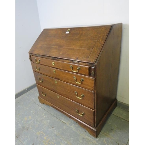 811 - An 18th century oak bureau, the fall front housing a fitted interior, above four graduated long draw... 