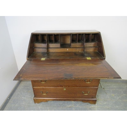 811 - An 18th century oak bureau, the fall front housing a fitted interior, above four graduated long draw... 