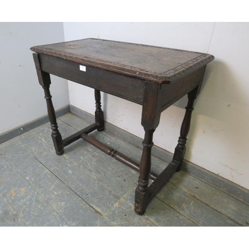 815 - An antique, probably 17th century, oak side table, the top with relief carved border, above a plain ... 