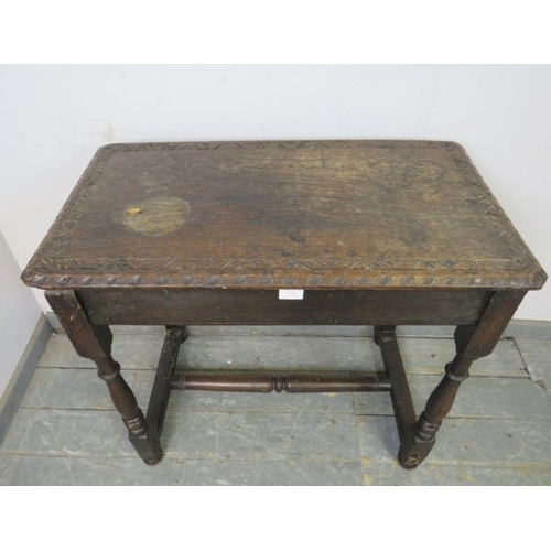 815 - An antique, probably 17th century, oak side table, the top with relief carved border, above a plain ... 