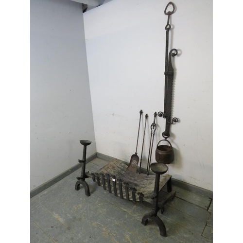 816 - A pair of 17th century or earlier cast iron fire dogs, together with a bespoke fire basket, chimney ... 