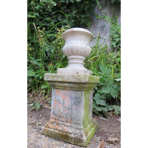 830 - A small weathered white marble fluted urn, on an associated terracotta plinth. 
H52cm W23cm D23cm (a... 