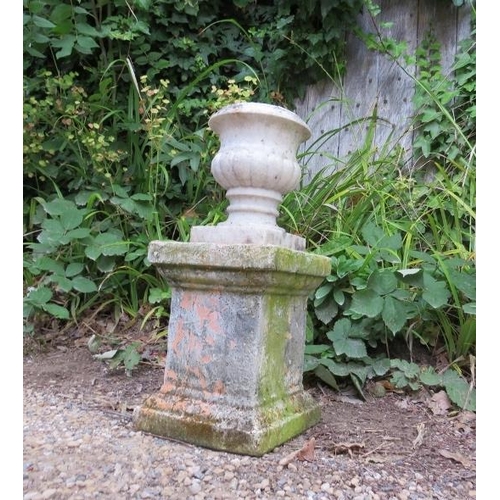 830 - A small weathered white marble fluted urn, on an associated terracotta plinth. 
H52cm W23cm D23cm (a... 