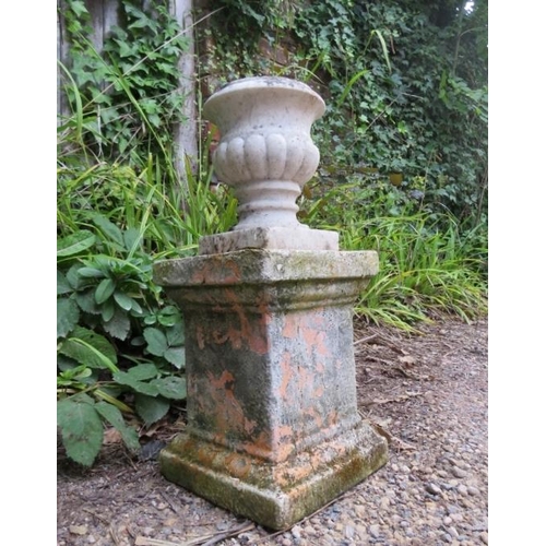 830 - A small weathered white marble fluted urn, on an associated terracotta plinth. 
H52cm W23cm D23cm (a... 