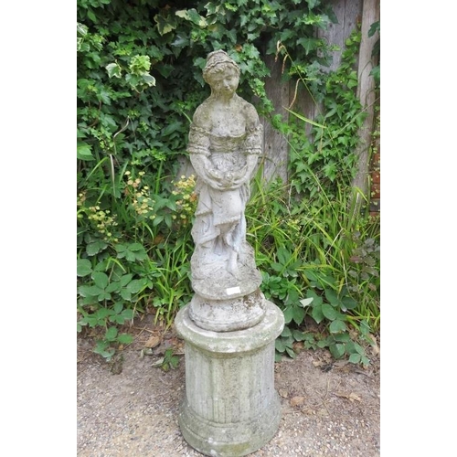 833 - A weathered reconstituted stone garden statue modelled as a girl holding a dove, on a reeded column ... 