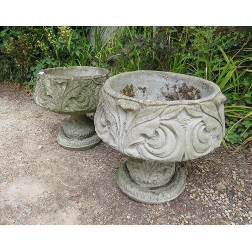 834 - A pair of weathered reconstituted stone garden urn planters having relief moulded acanthus leaf deco... 