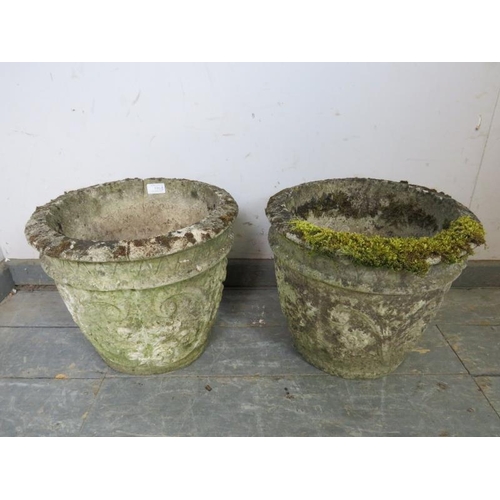 838 - A pair of weathered reconstituted stone garden planters, with relief moulded scrolled decoration.
H3... 