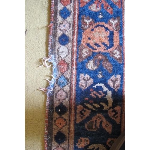 869 - An antique early 20th century Malayer rug with overall Boteh motifs and a three tier border. Rust/te... 