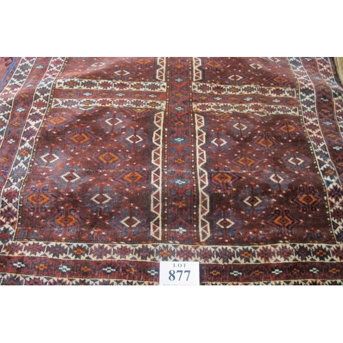 877 - A fine Yomud Turkoman early 20th century rug with four sectioned repeat central pattern on deep red ... 