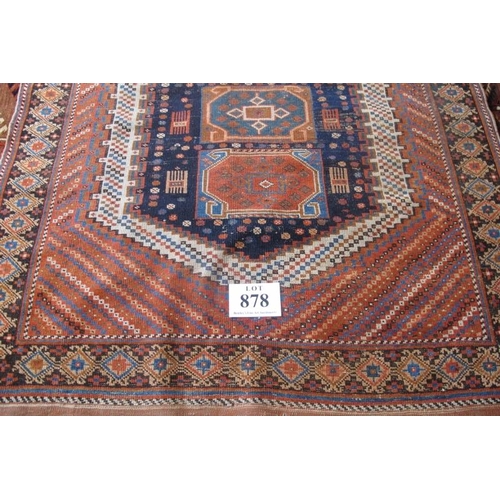 878 - A Persian Afshar rug with central panel containing four large motifs on blue ground, flanked by a bl... 