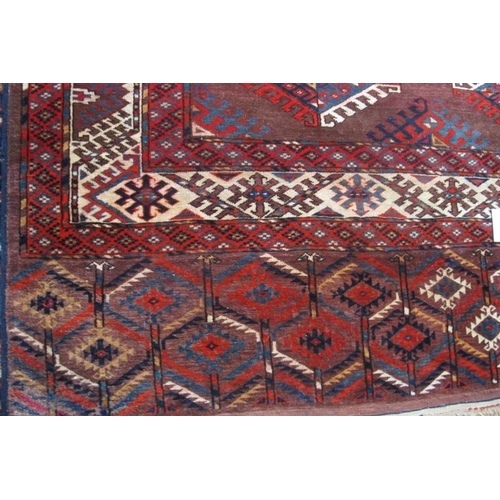 879 - A large Turkoman Yomut 20th century carpet with a repeat central pattern and deep borders. 360cm x 2... 