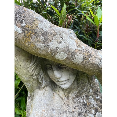 836 - A large weathered reconstituted stone garden statue modelled as a Classical maiden, on a square plin... 