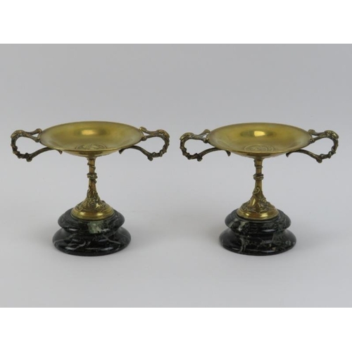 10 - A pair of Italian Grand Tour twin handled tazzas, 19th century. Cast in brass and mounted on marble ... 