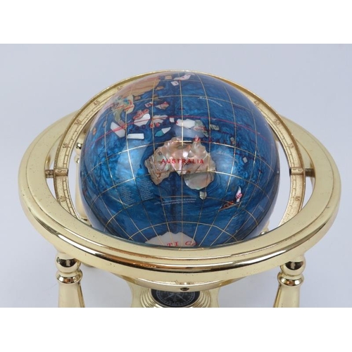 100 - A desktop gemstone globe with compass, late 20th century. 24 cm height. 
Condition report: Some age ... 