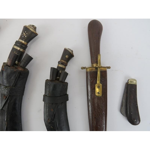 109 - Five vintage Kukri daggers, an Indian carved wood knife, a penknife and a regimental wall shield pla... 