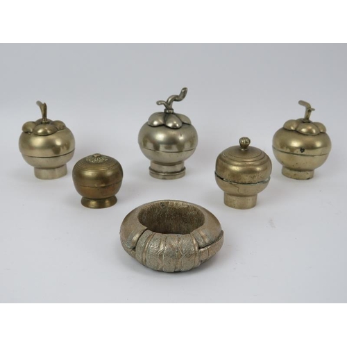 110 - Five Indonesian metal betel nut container jars with covers and and a solid metal amulet, 19th centur... 