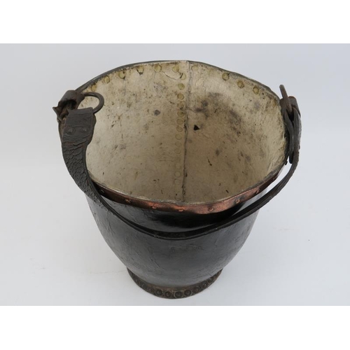 133 - A Georgian copper banded and studded leather fire bucket with strap handle, 18th century.
Condition ... 