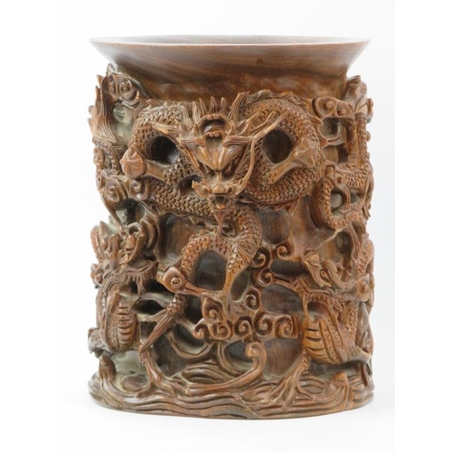 135 - A large Chinese carved wood brush pot, 20th century. Profusely decorated in high relief depicting dr... 