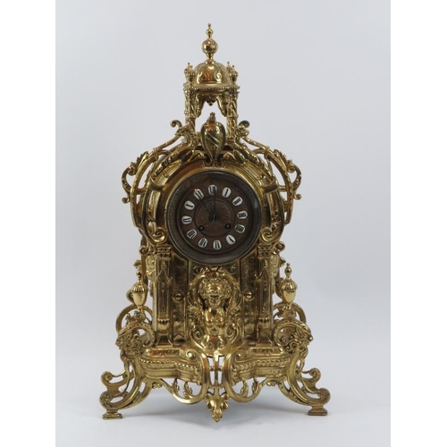 139 - A large Baroque style brassed metal mantel clock, late 19th/early 20th century. Keys and pendulum in... 