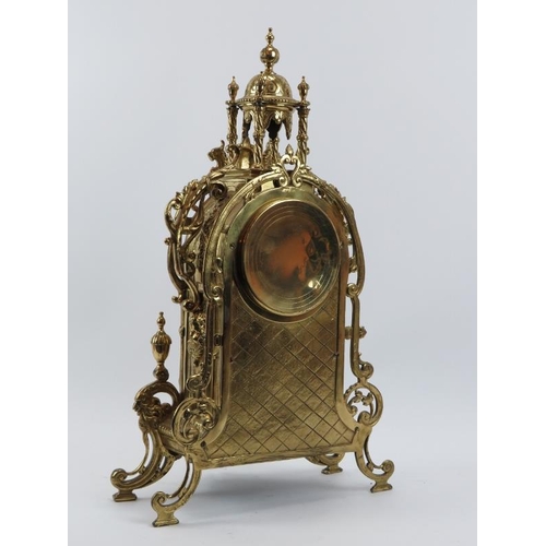 139 - A large Baroque style brassed metal mantel clock, late 19th/early 20th century. Keys and pendulum in... 