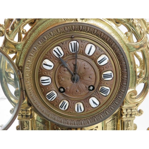 139 - A large Baroque style brassed metal mantel clock, late 19th/early 20th century. Keys and pendulum in... 