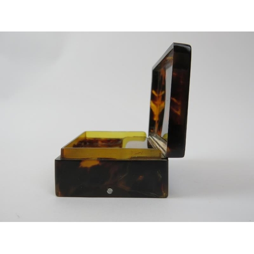 166 - A rare Swiss miniature tortoiseshell musical snuff box, 19th century. With a horn dust cover display... 