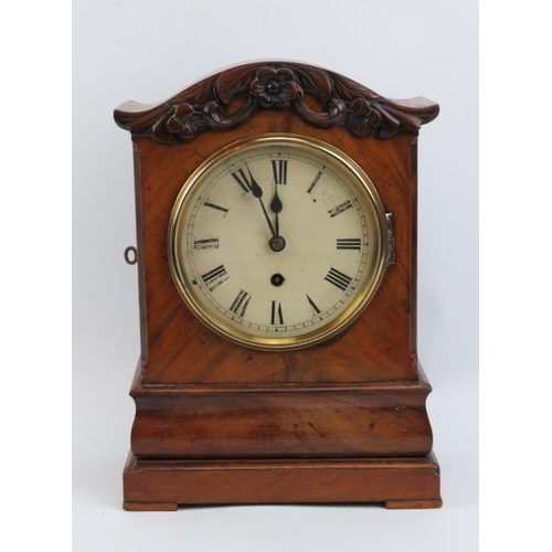 177 - A Victorian walnut mantle clock. White enamelled dial with Roman numerals. Key and pendulum included... 